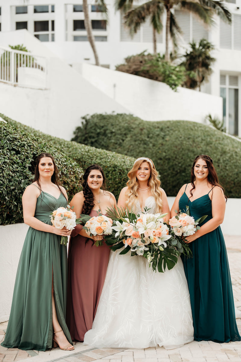 Bride with Bridesmaids in Different Color Dresses at Elegant Tropical Wedding