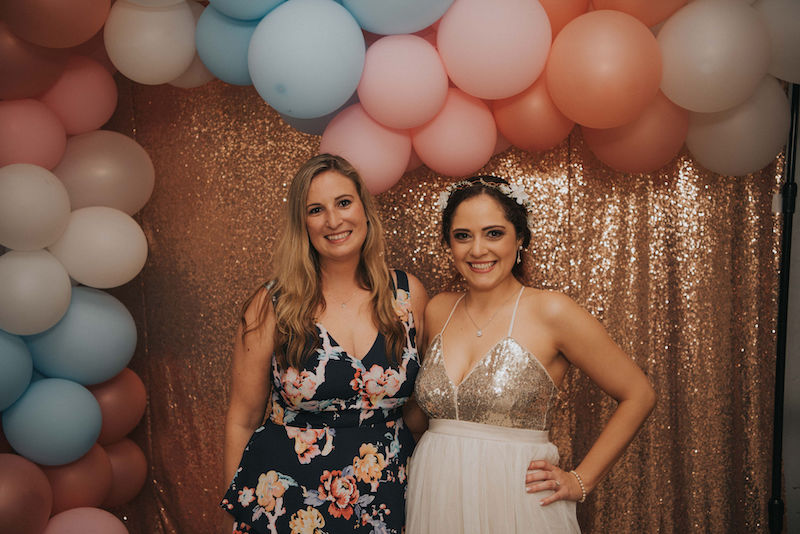bride and friend balloon arch