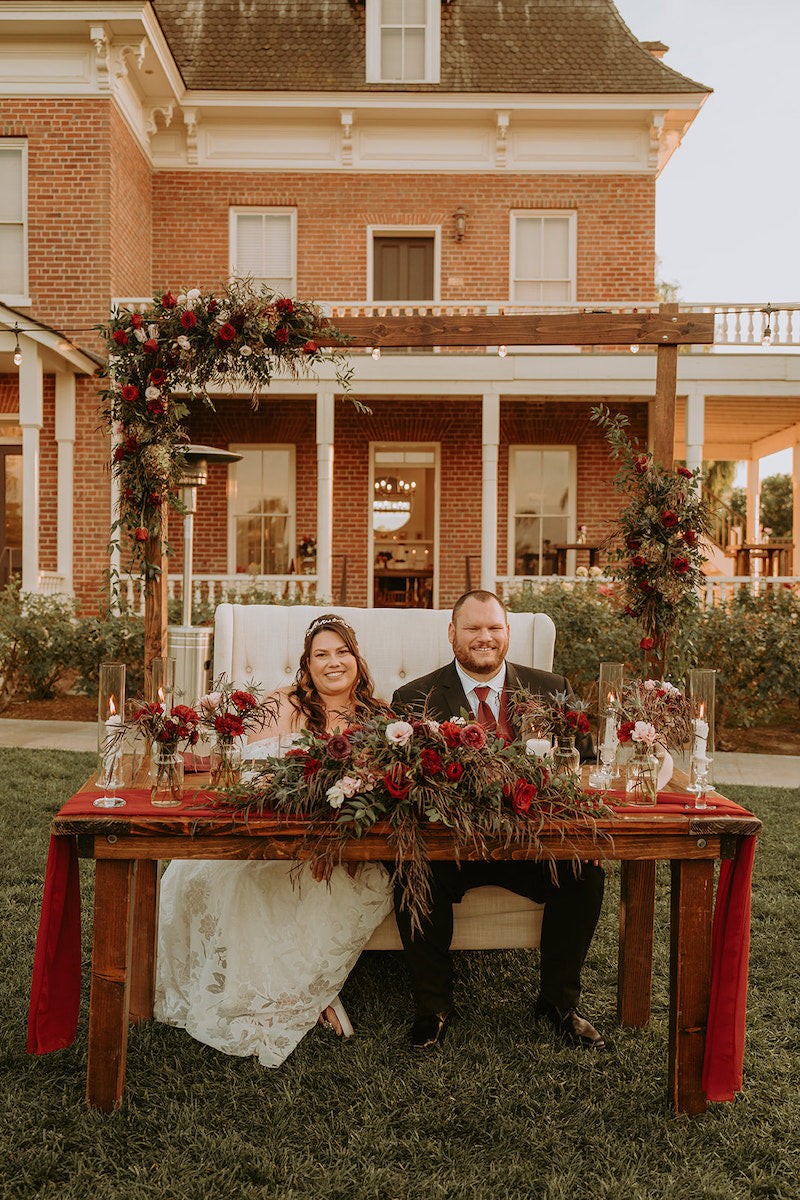 Bride and Groom at Sweetheart Table Outdoor Wedding Reception