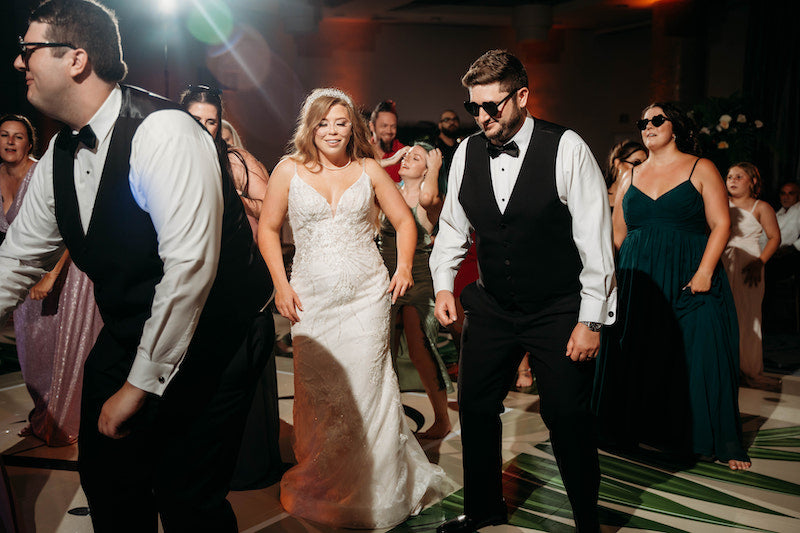 Bride and Groom Dance with Fun Sunglasses at Elegant Tropical Wedding