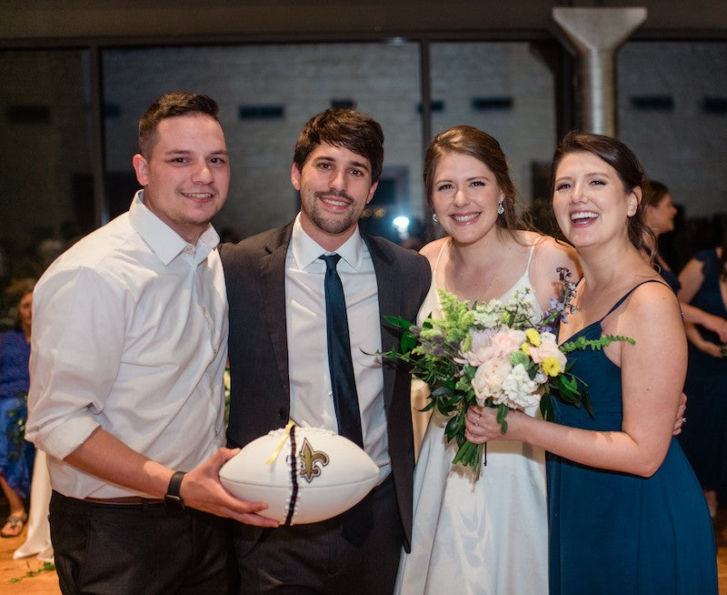 Bride and Groom and Guests with Bridal Garter on Football after Garter Toss