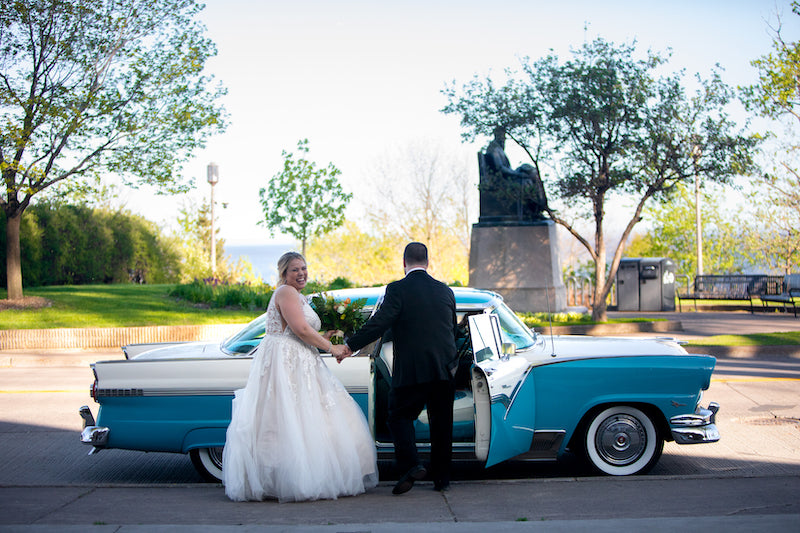 Bride and Groom Leave In Vintage Car