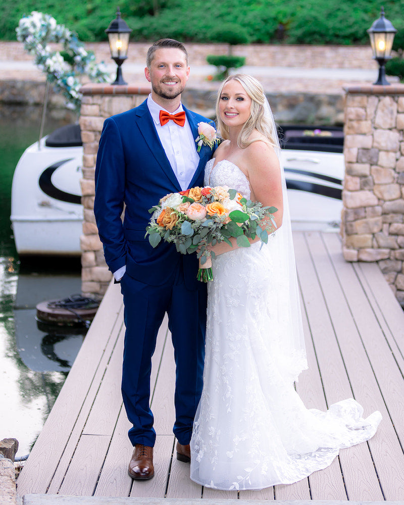 Bride and Groom On Dock With Orange Bridal Bouquet