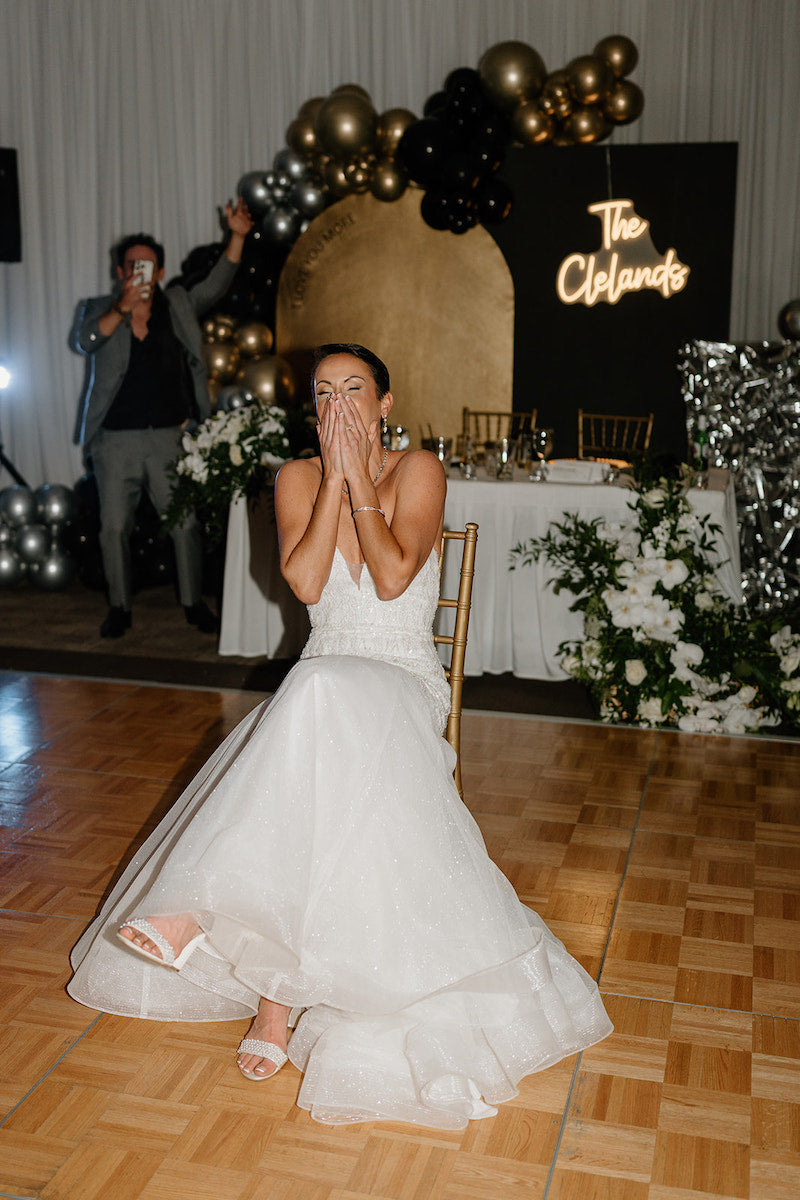 Bride Getting Ready for Garter Toss New Years Wedding