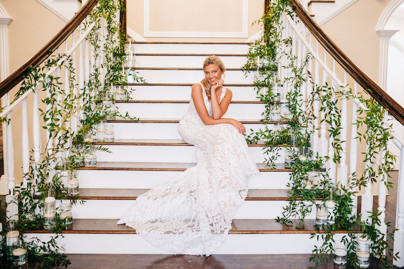 Bride Posing on Staircase with Wedding Flowers