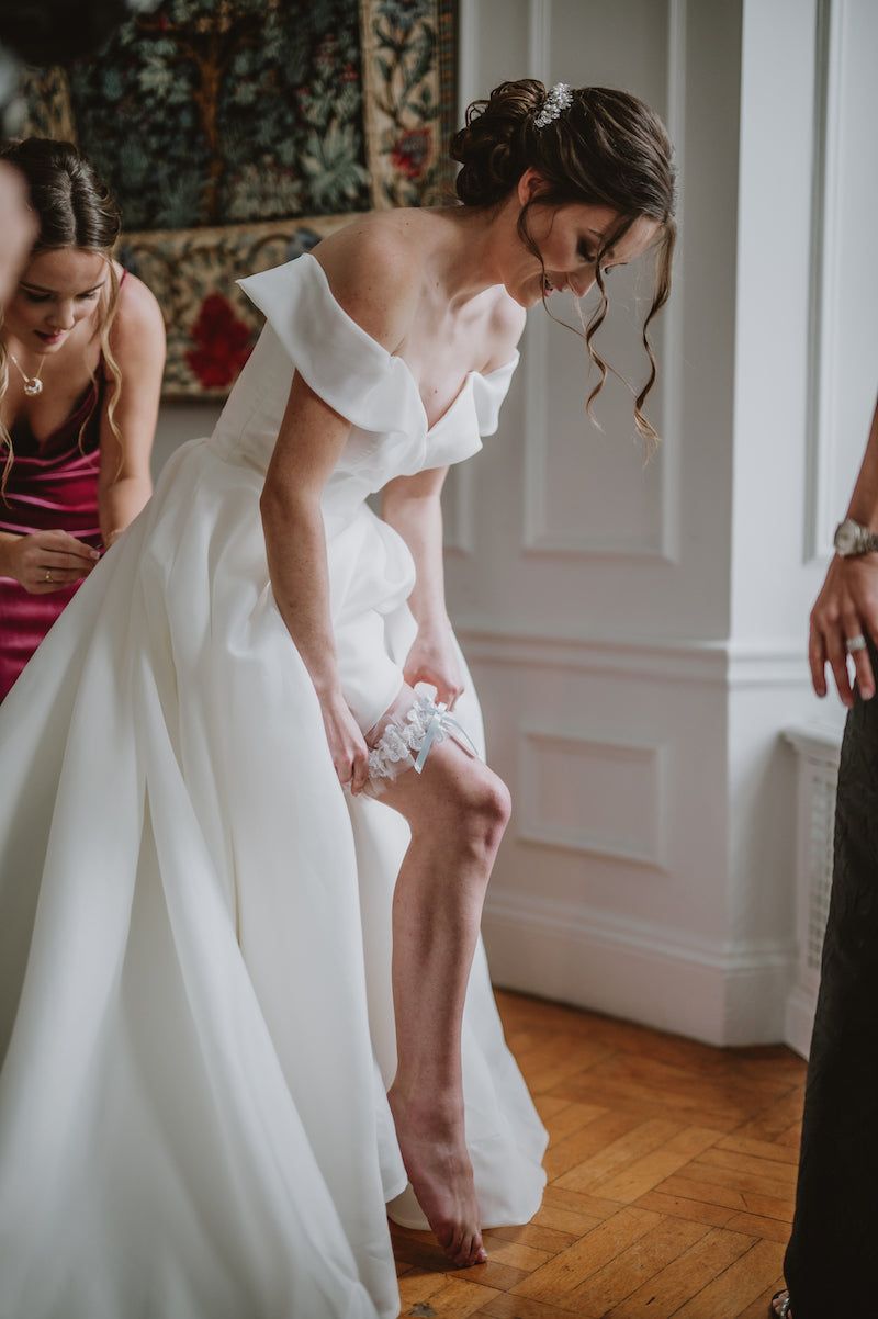 Bride Wearing Bridal Garter Made From Moms Wedding Dress