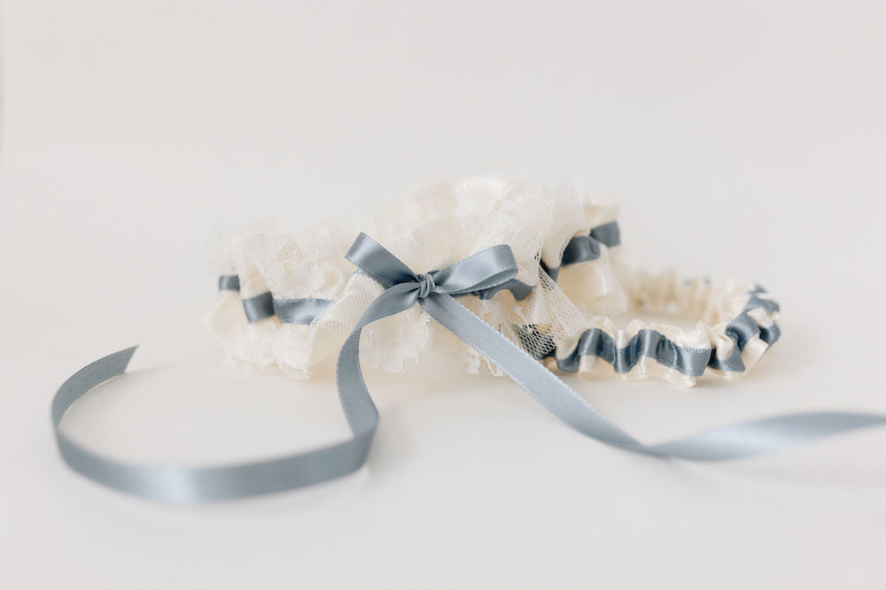 cream wedding garter set with dusty blue ribbon and embroidery handmade by wedding expert The Garter Girl