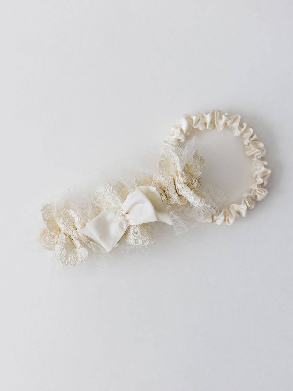 custom garter set with ivory lace main garter and satin tossing garter made from grandmother's lace wedding dress and pearls by The Garter Girl