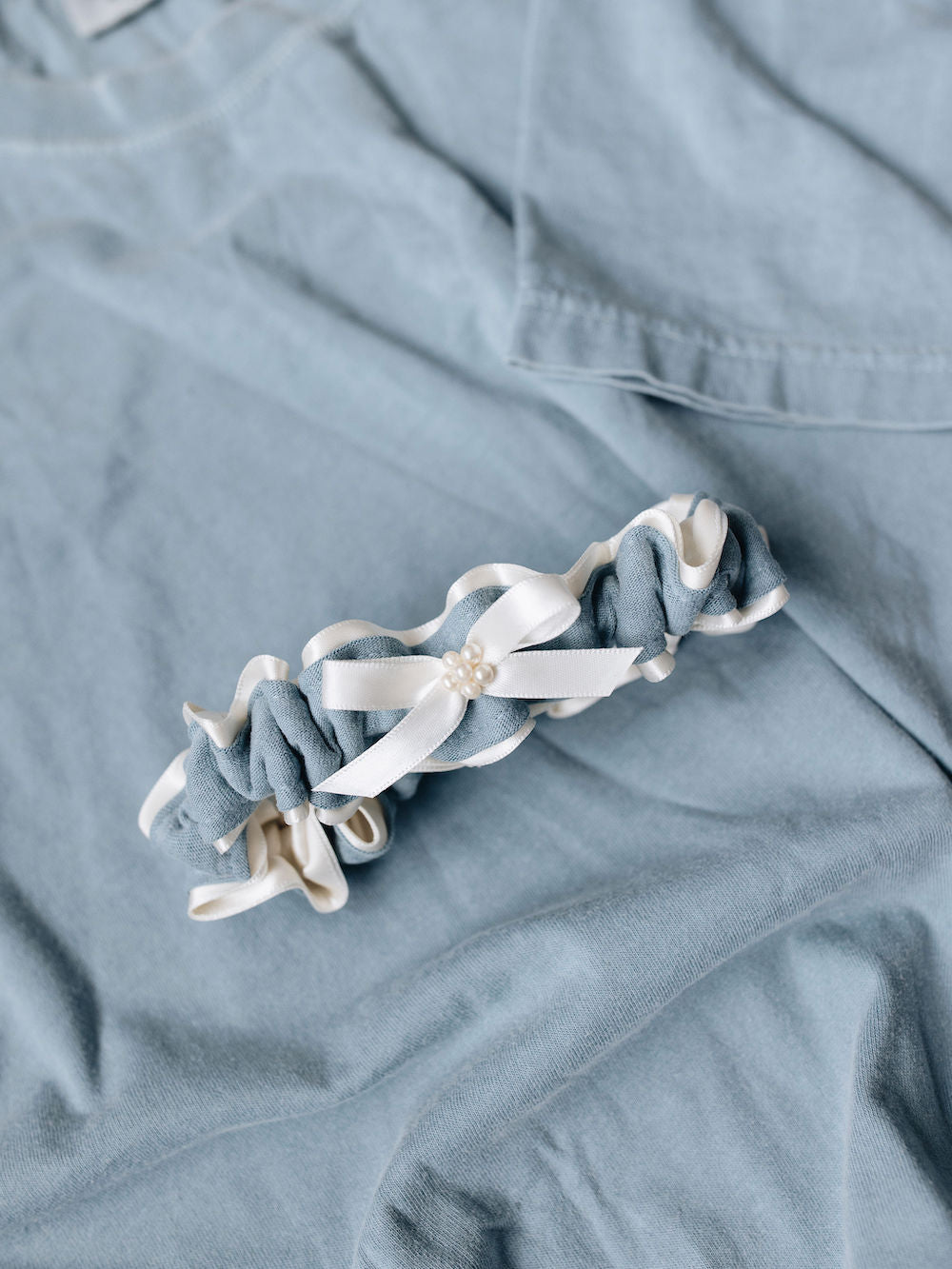main garter made with ivory tulle and pearls and blue stripe from father's t-shirt handmade by The Garter Girl