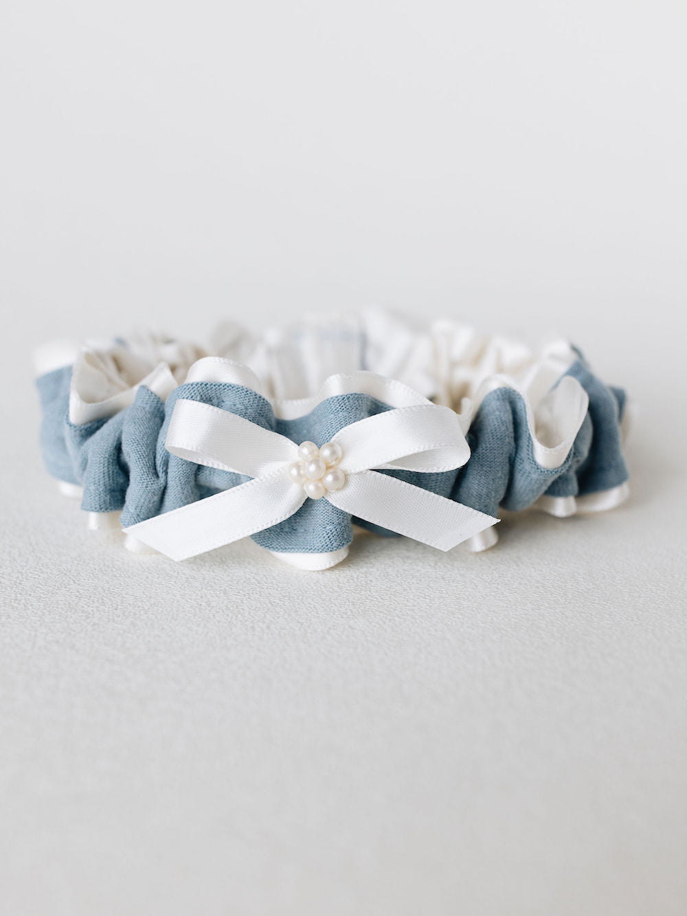 custom garter with ivory tulle and pearls main garter with blue stripe from dad's t-shirt handmade by The Garter Girl