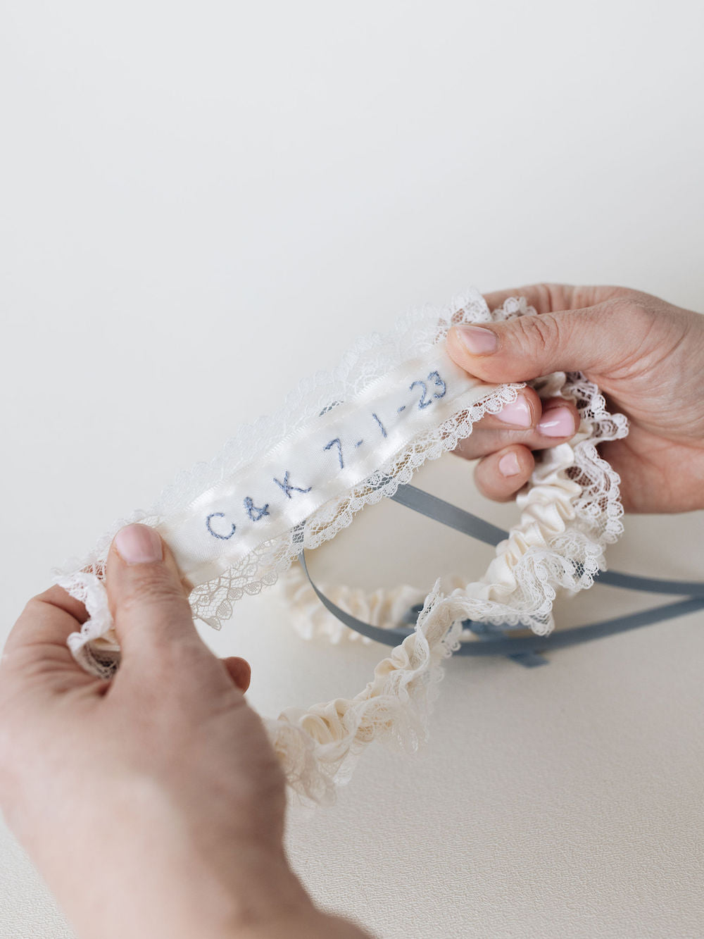 embroidery detailing hand-stitched on custom, personalized wedding garter with ivory lace handmade by The Garter Girl