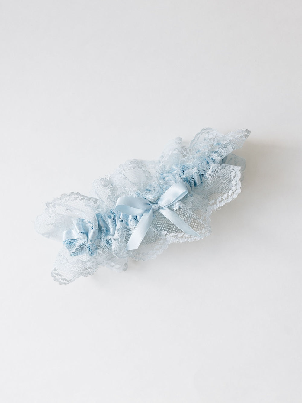 delicate baby blue lace wedding garter heirloom with same-color blue satin short-tailed bow handmade by The Garter Girl