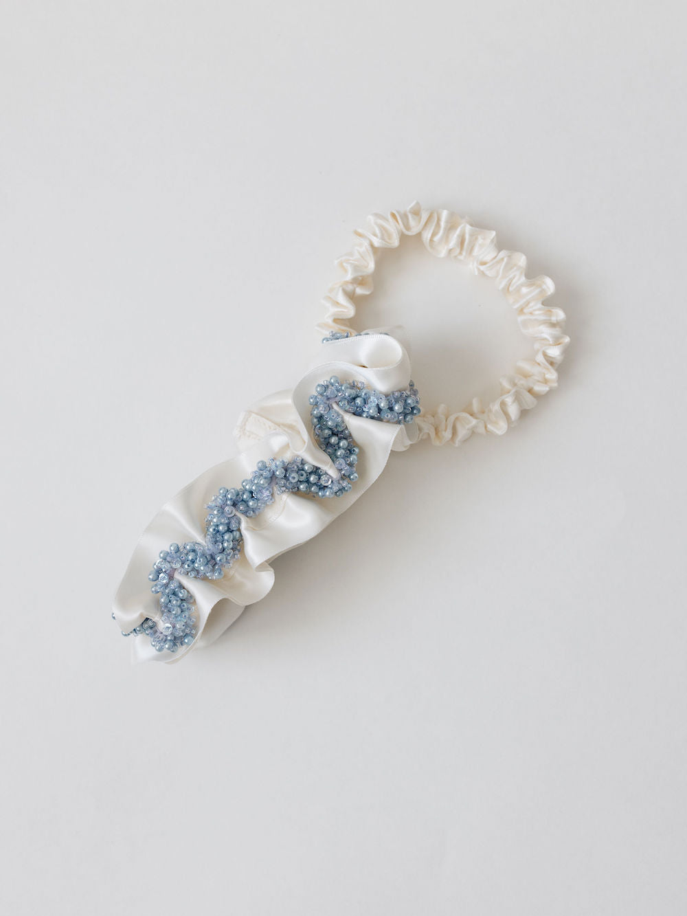 heirloom garter set with ivory satin and a main garter with blue sparkly beading handmade by The Garter Girl