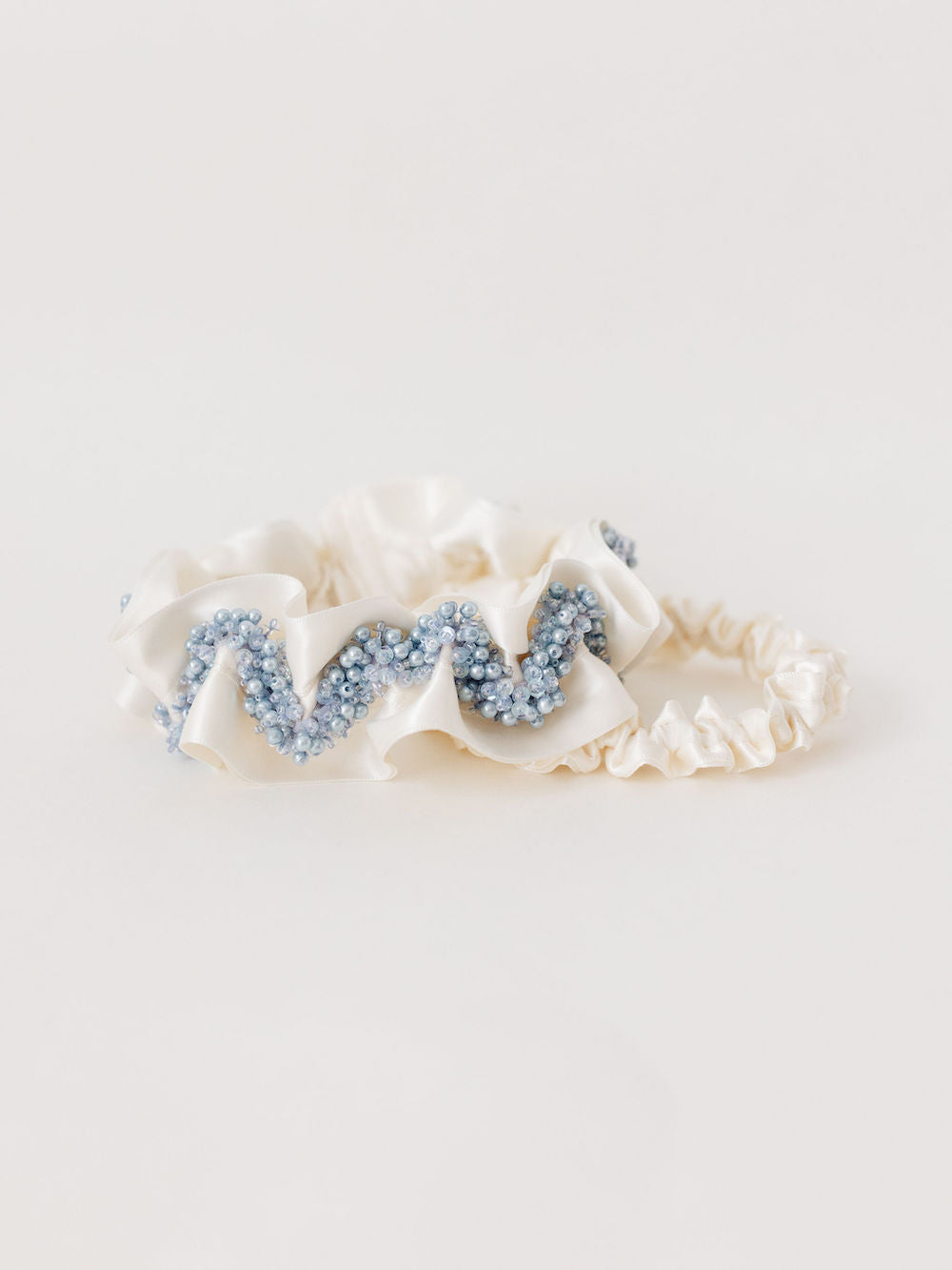 heirloom garter set with ivory satin and a main garter with blue sparkly beading handmade by The Garter Girl