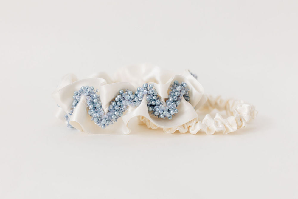 heirloom garter set with ivory satin and a main garter with blue sparkly beading handmade by The Garter Girl