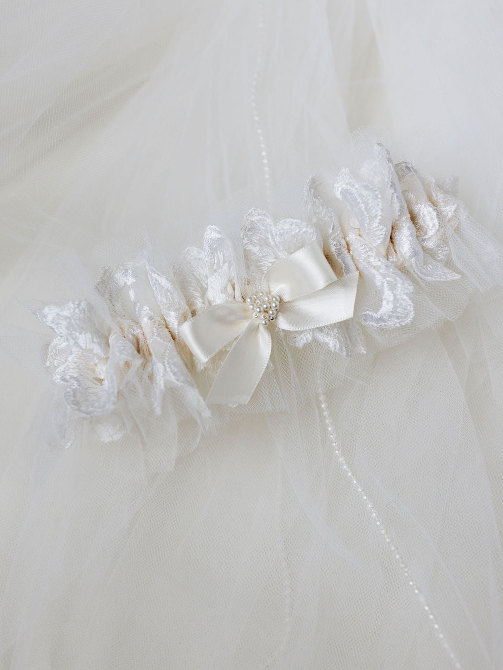 custom ivory tulle wedding garter heirloom made from mother's wedding veil handmade with pearl detailing by The Garter Girl