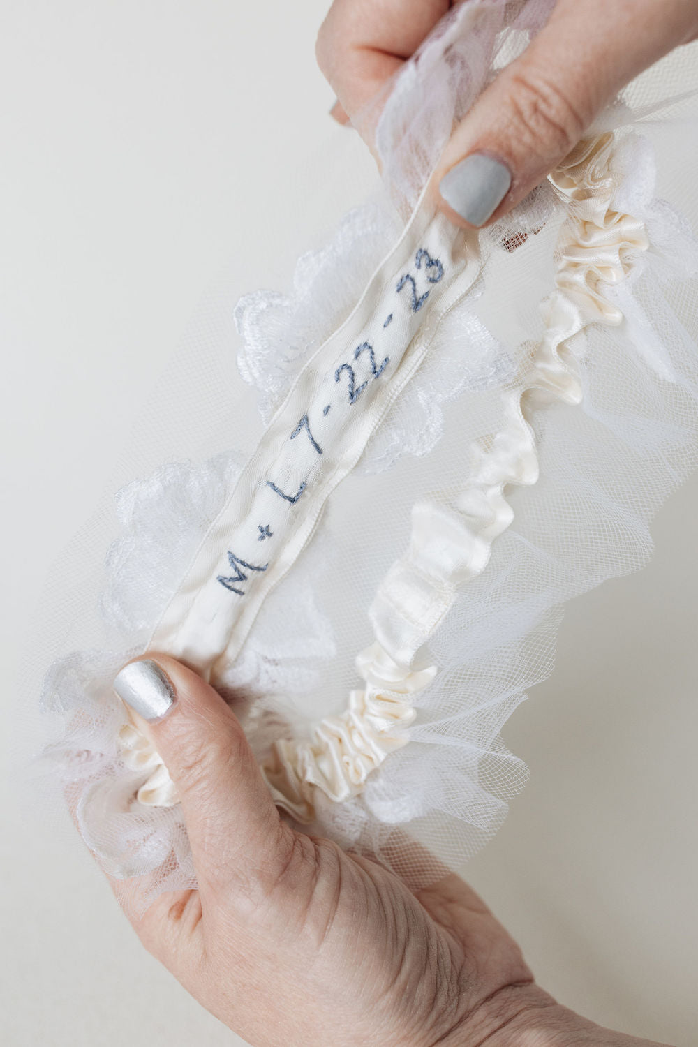 custom embroidery in blue thread on heirloom ivory tulle wedding garter with pearl detailing handmade by The Garter Girl