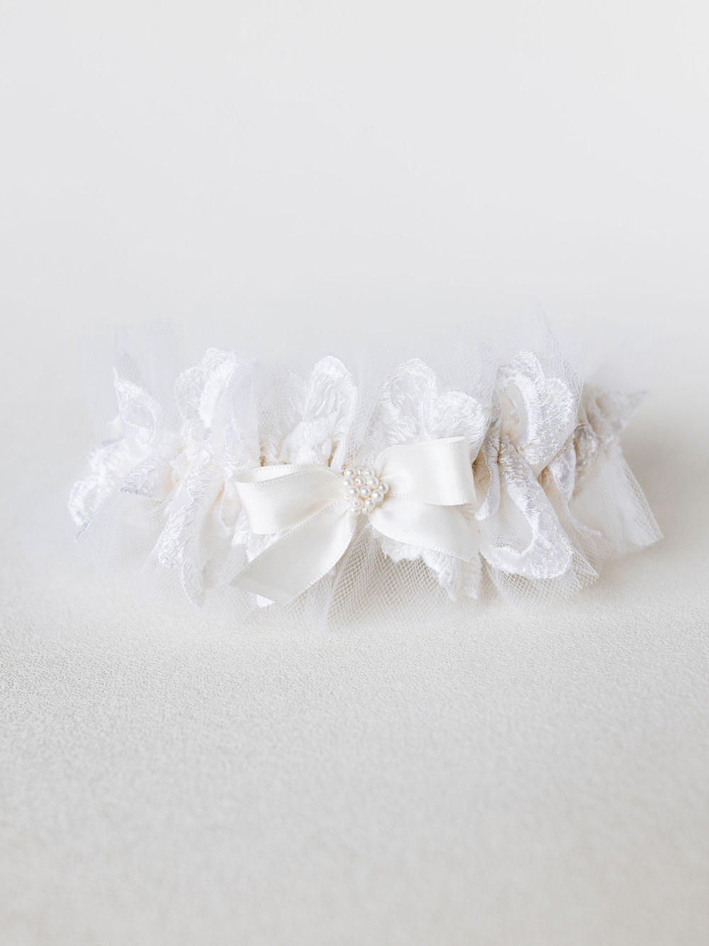 custom pearls and ivory tulle wedding garter heirloom made from mother's wedding veil handmade by The Garter Girl