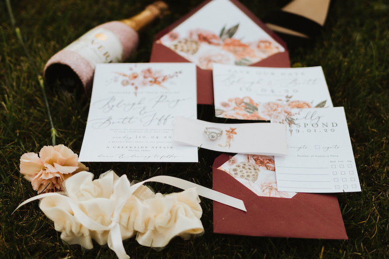 Floral Invitation Suite and Bridal Garter Flat Lay