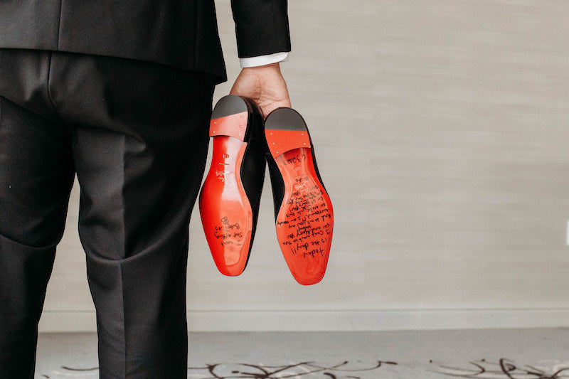 Groom Christian Louboutin Shoes with Message From Bride Written on Red Bottoms