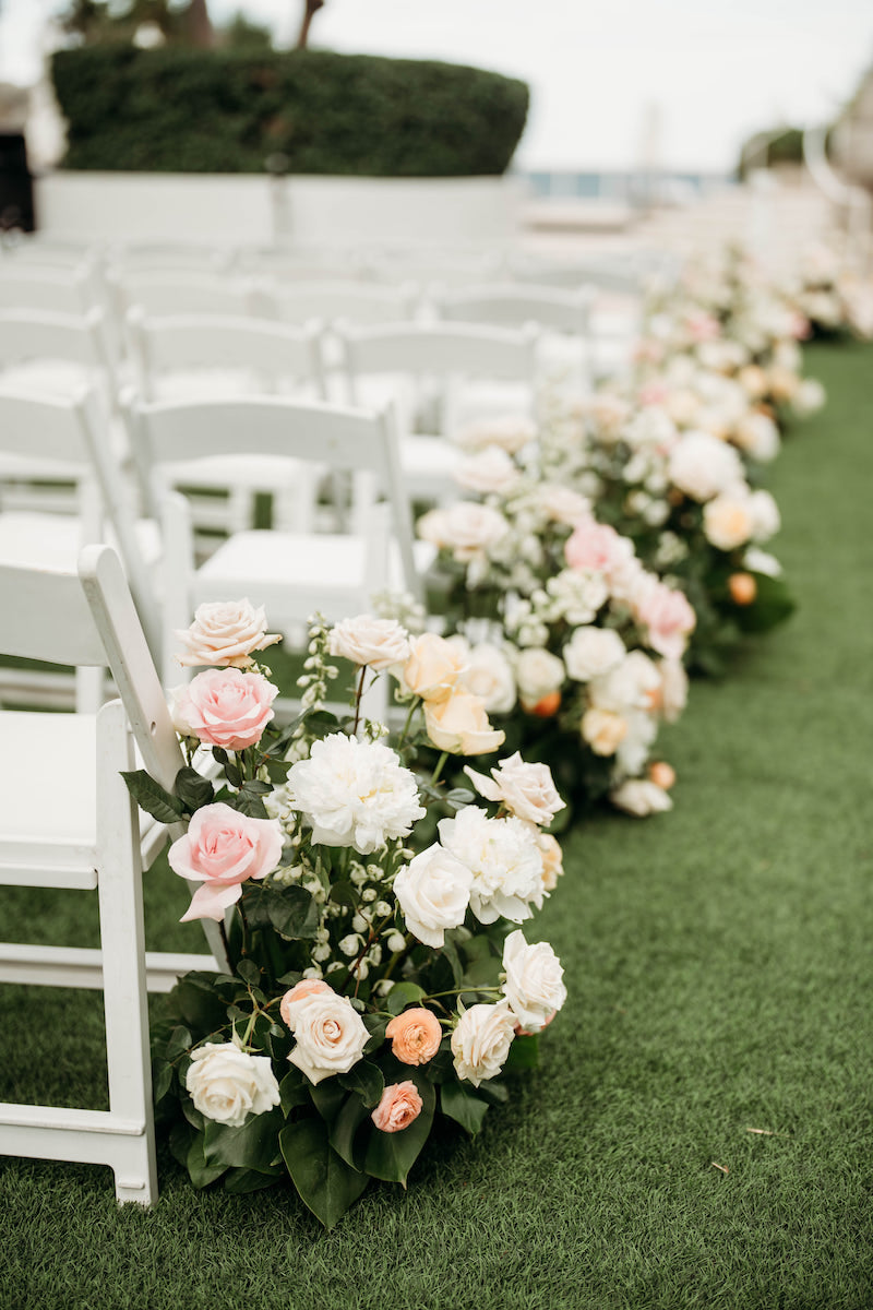Ivory and Blush Flowers Line Aisle at Elegant Tropical Wedding