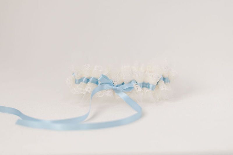 custom wedding garter with ivory tulle and lace with light blue satin and personalized with a pink heart embroidered