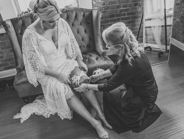 Bride and Mother Getting Ready Bridal Garter Placement