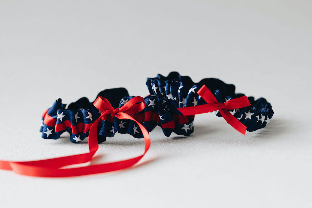 patriotic usa themed, red, white & blue wedding garter set personalized with couple's names and wedding date handmade bridal accessory by The Garter Girl