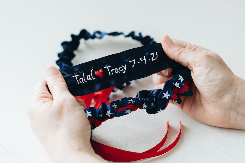 patriotic usa themed, red, white & blue wedding garter set personalized with couple's names and wedding date handmade bridal accessory by The Garter Girl