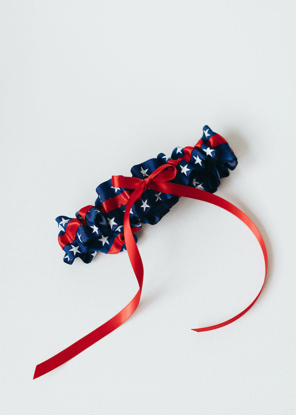 patriotic usa themed, red, white & blue wedding garter set personalized with couple's names and wedding date handmade bridal accessory by The Garter Girl