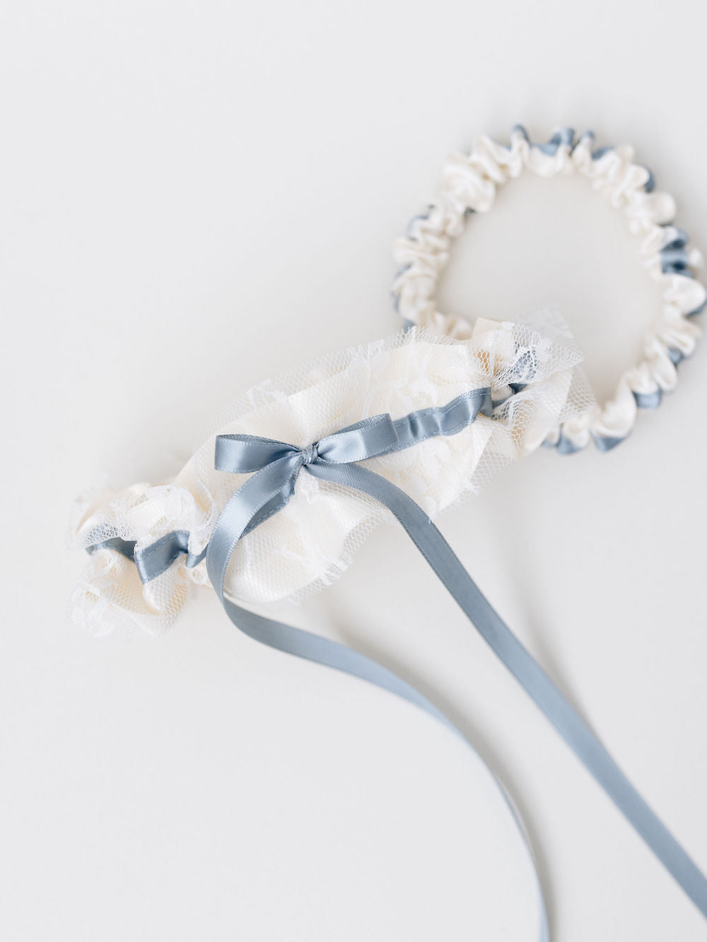 wedding garter set handmade with something blue detailing and ivory satin and lace by The Garter Girl