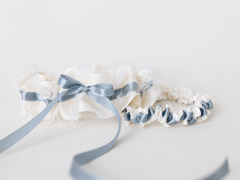 wedding heirloom garter set with something blue ribbon detailing and ivory satin and lace handmade by The Garter Girl