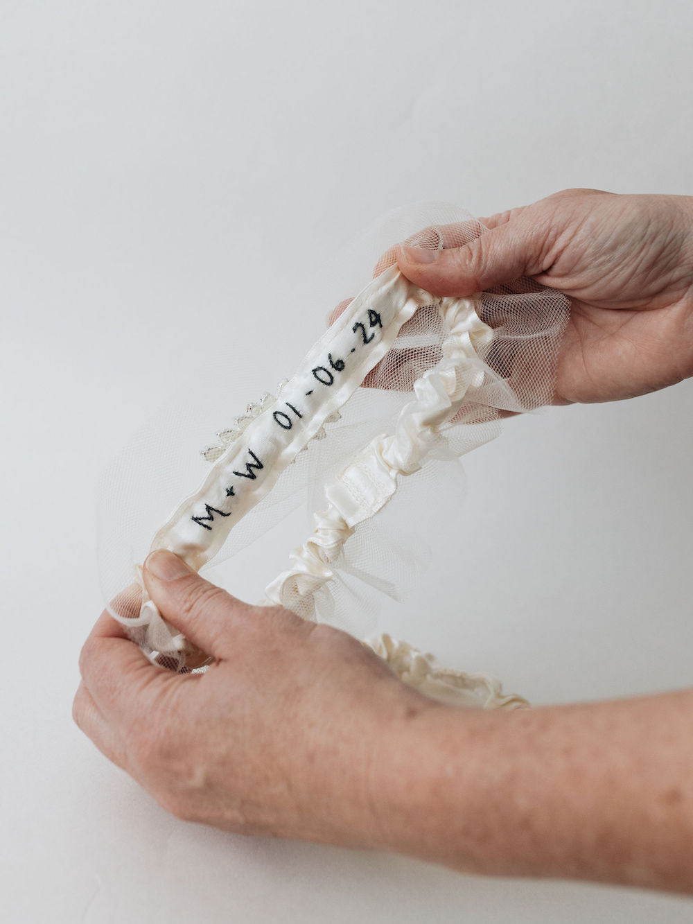 ivory tulle wedding garter heirloom with black embroidery on the main garter with sparkle rhinestone detailing handmade by The Garter Girl