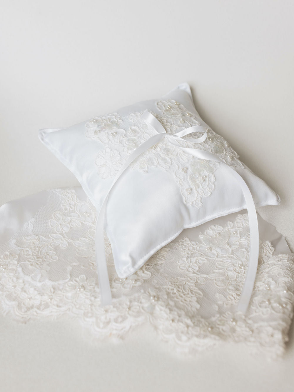 a wedding ring bearer pillow handmade with lace and pearls from the bride's mother's wedding dress by expert heirloom designer, The Garter Girl