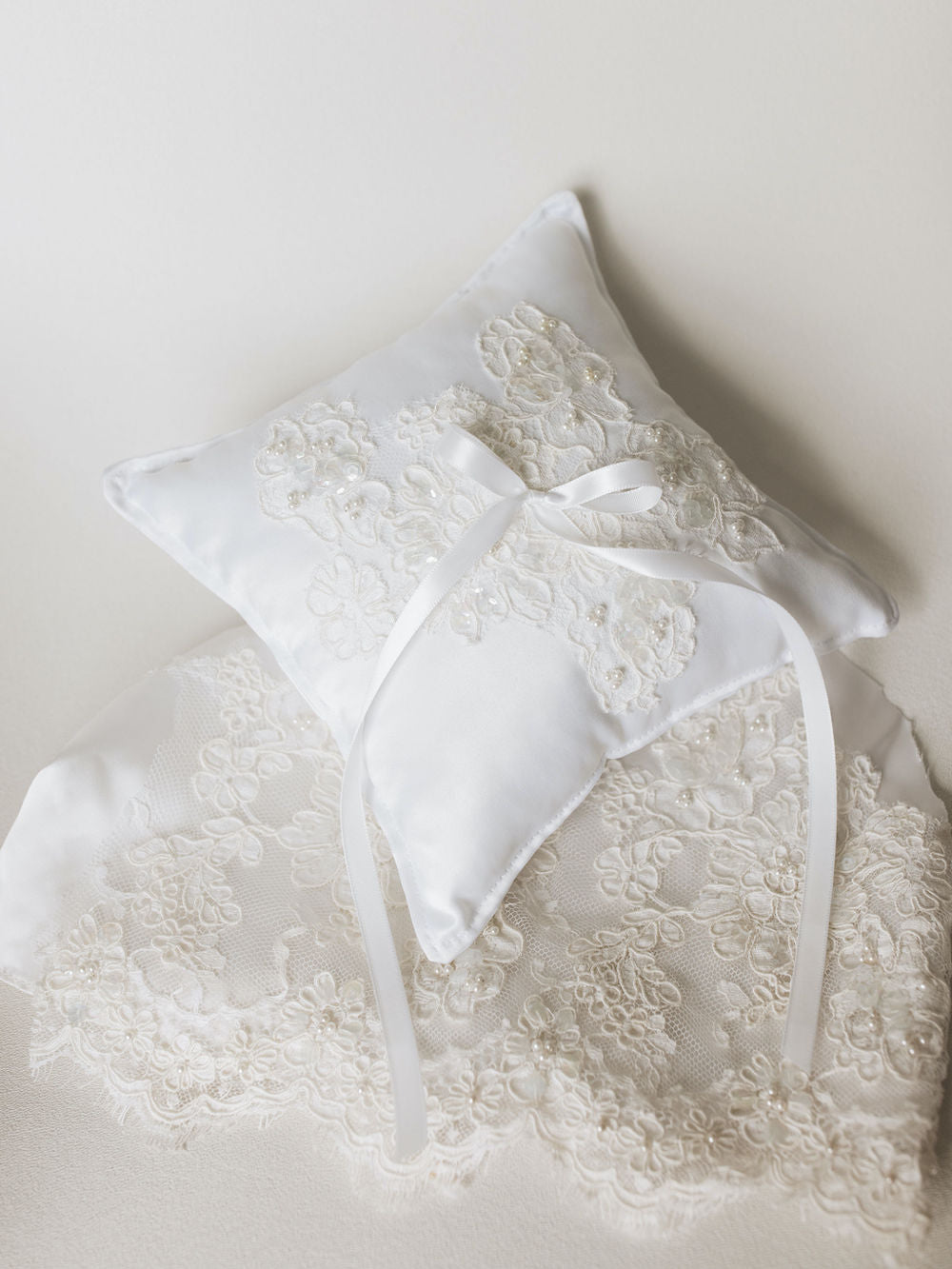 a wedding ring bearer pillow handmade with lace and pearls from the bride's mother's wedding dress by expert heirloom designer, The Garter Girl