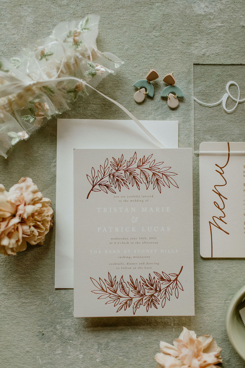 Rustic Barn Wedding Invitation Flay Lay with Floral Bridal Garter