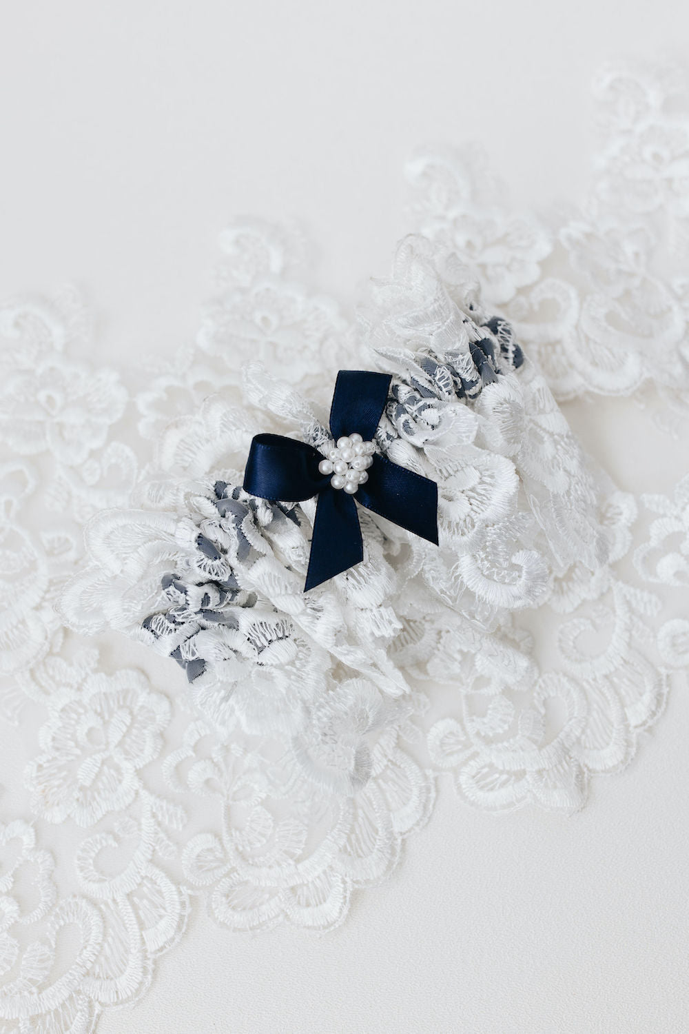 matching handkerchief and wedding garter set with navy blue satin & bow, ivory lace, and pearls - a handmade wedding heirloom by The Garter Girl