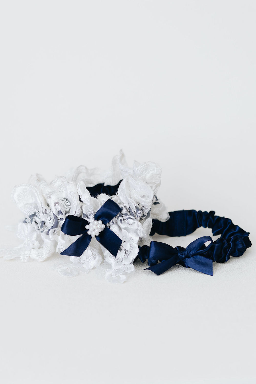 matching handkerchief and wedding garter set with navy blue satin & bow, ivory lace, and pearls - a handmade wedding heirloom by The Garter Girl