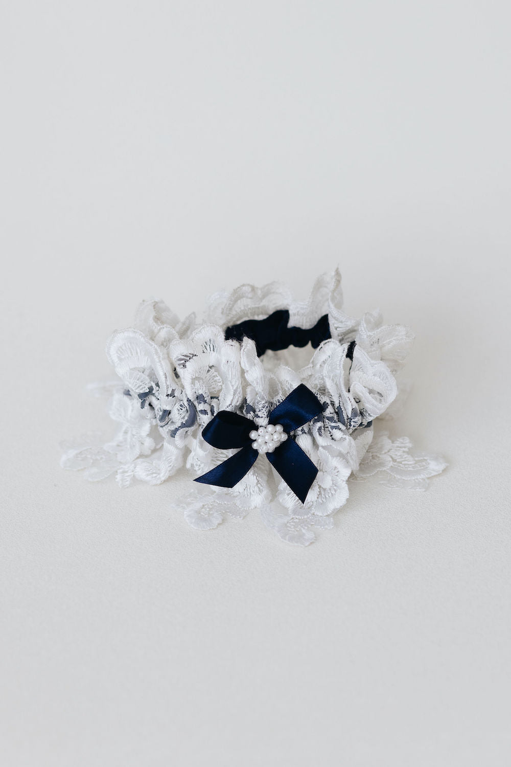 matching handkerchief and wedding garter set with navy blue satin & bow, ivory lace, and pearls - a handmade wedding heirloom by The Garter Girl