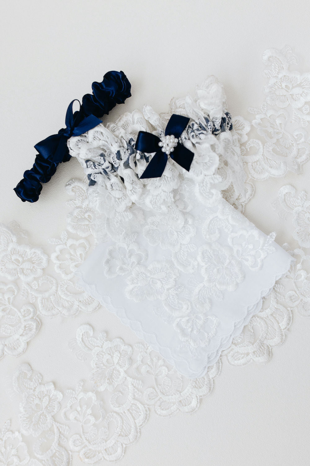 matching handkerchief and wedding garter set with navy blue satin & bow, ivory lace, and pearls - a handmade wedding heirloom by The Garter Girl