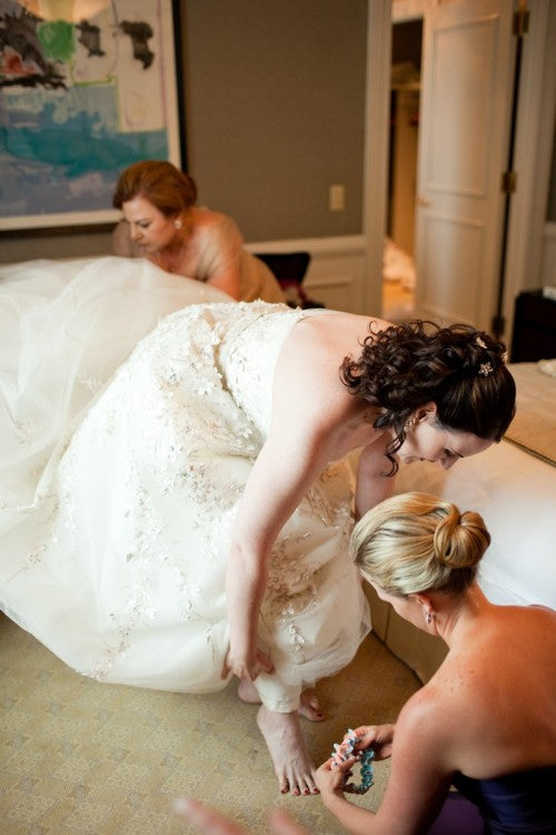 bride-putting-on-beautiful-garter-photo-by-paul-morse