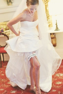bride-putting-on-designer-wedding-garter-vanessa-joy-photography