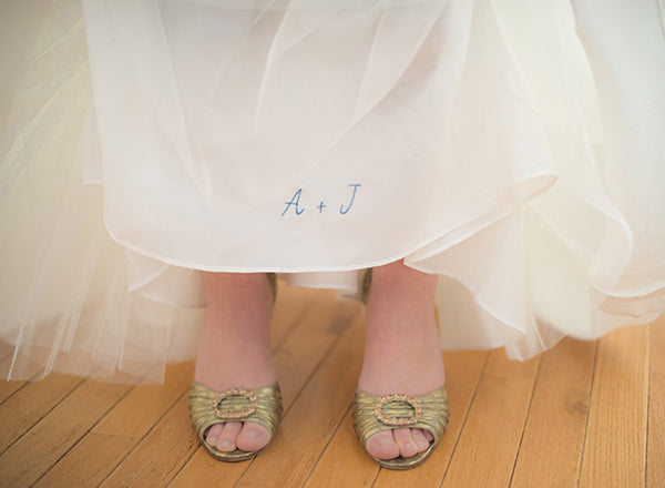 bride with gold wedding shoes and embroidered wedding dress