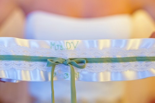 white-lace-and-sage-green-wedding-garter-vanessa-joy-photography