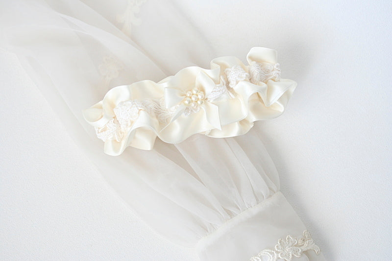 wedding garter made from bride's mother's wedding dress sleeve with lace and pearls