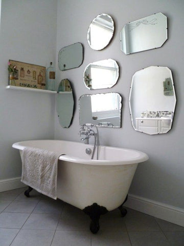 bathroom wall full of mirrors