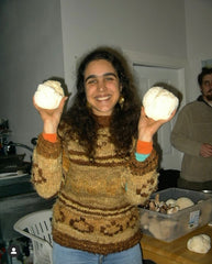 A photo of Giuliana Furci holding up two mushrooms in each hand