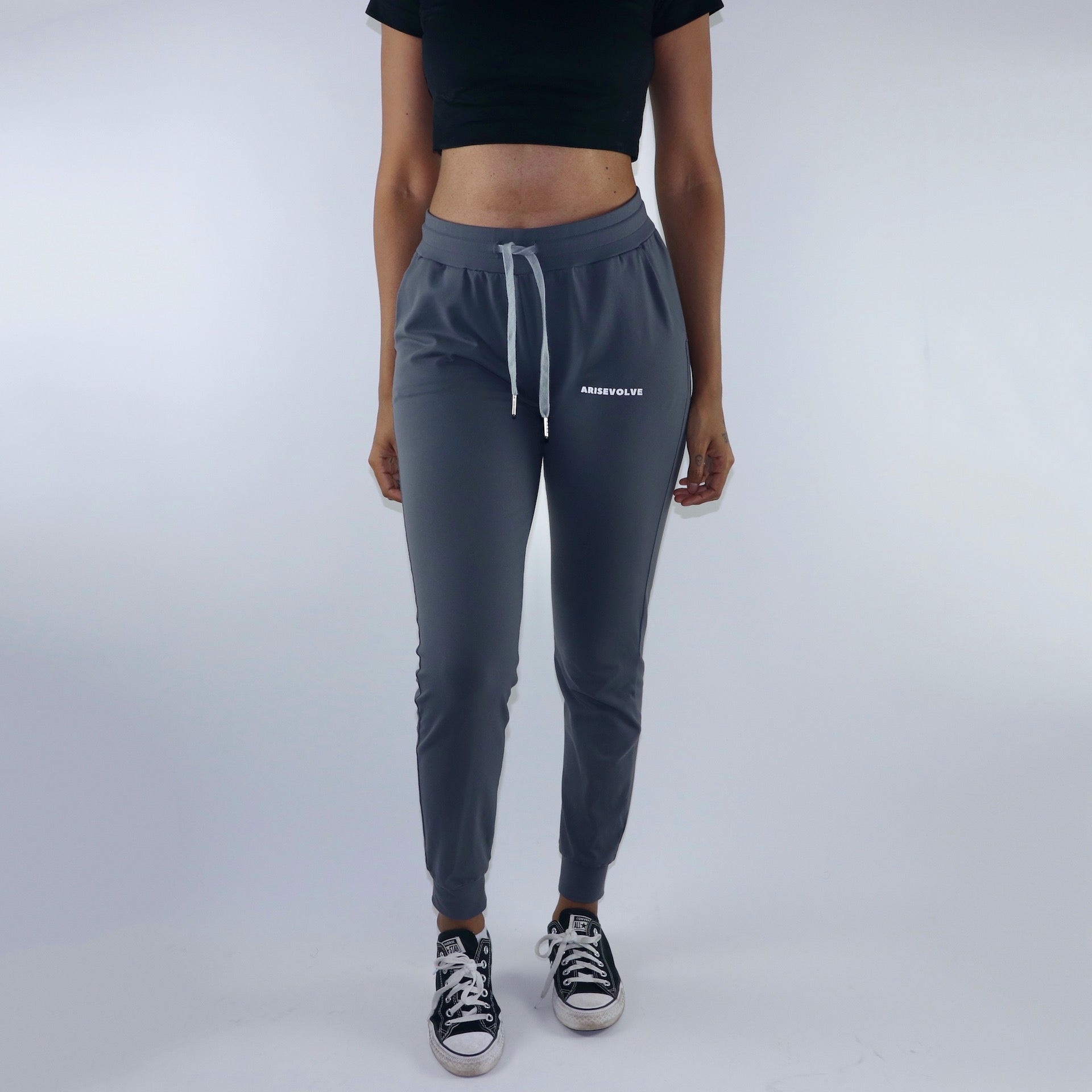 Front view of women's grey activewear joggers with 2 side pockets. Cuffed ankles and mid waist rise.