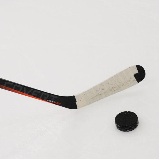 Warrior Covert blade on the ice with a puck