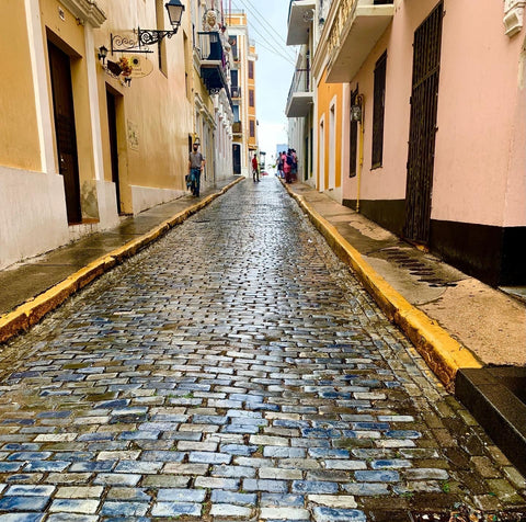 Blue Cobblestone street looking up a hill in Old San Juan Puerto Rico